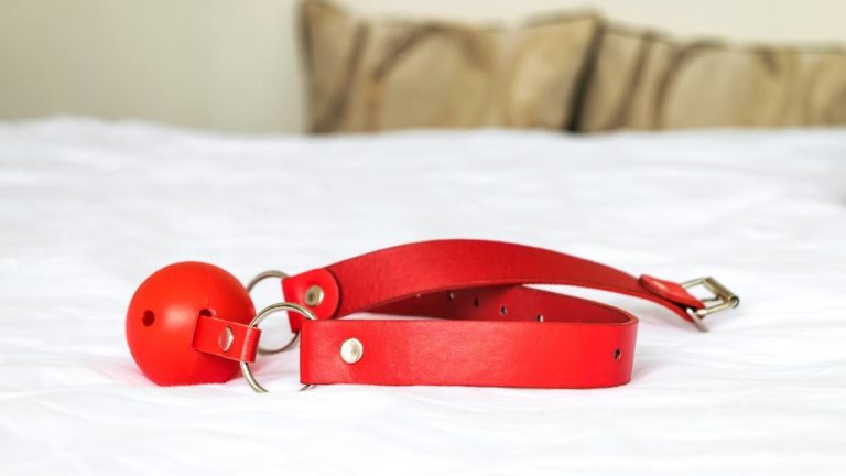 red ball gag on bed